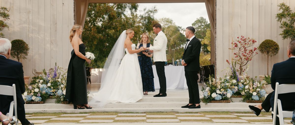 Madison and Craig exchanging rings at their ceremony